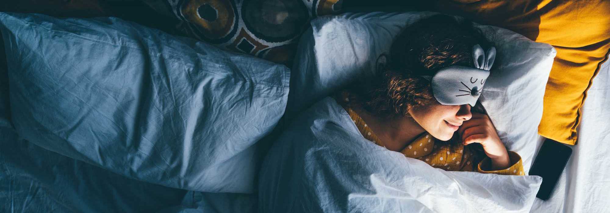 Woman sleeping with an eye mask on