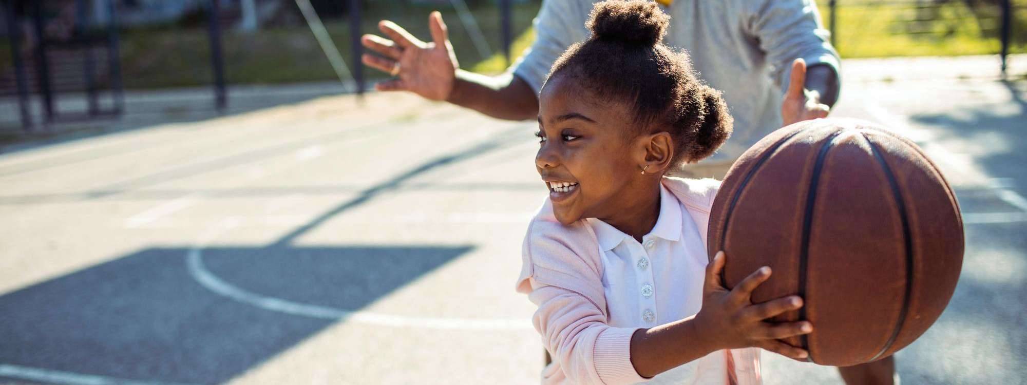 Little girl playing basketball