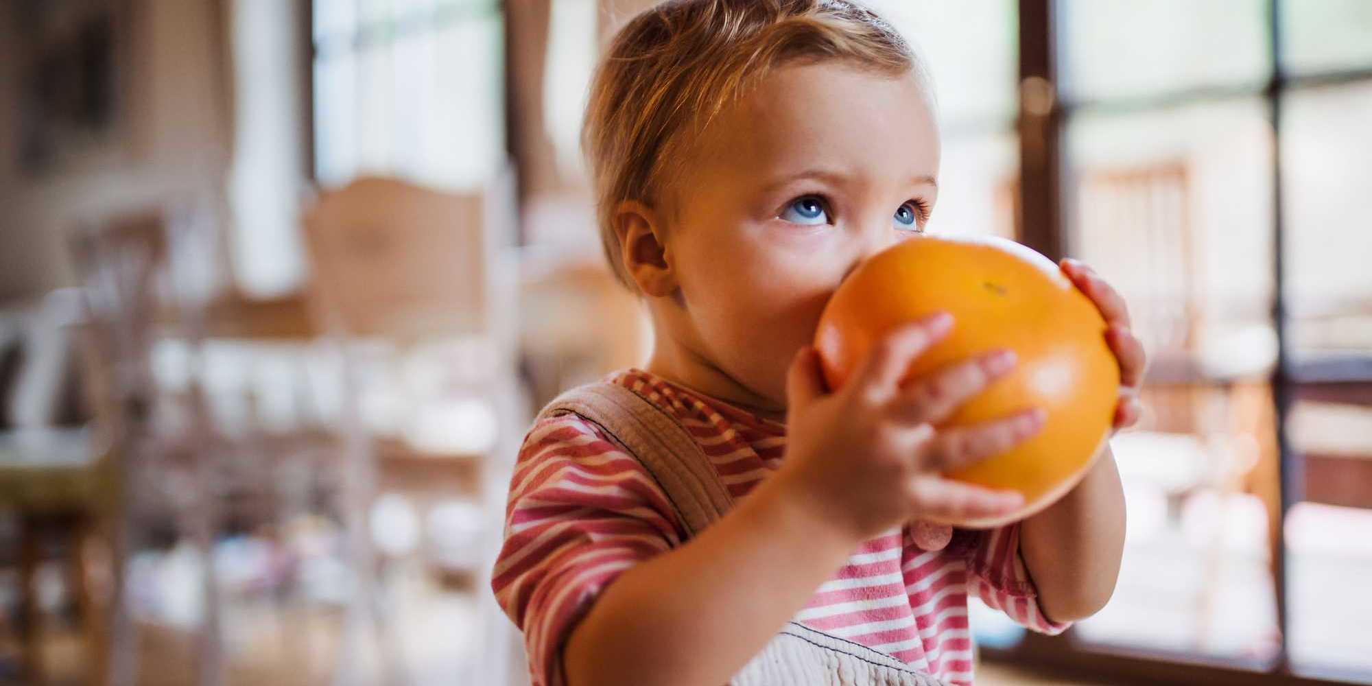 Child with a fruit