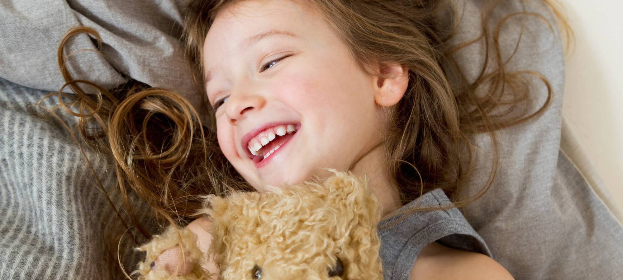 Little girl hugging her teddy bear